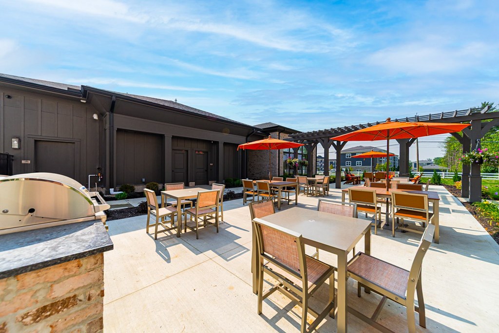 A patio with tables and chairs is set up outside a building.