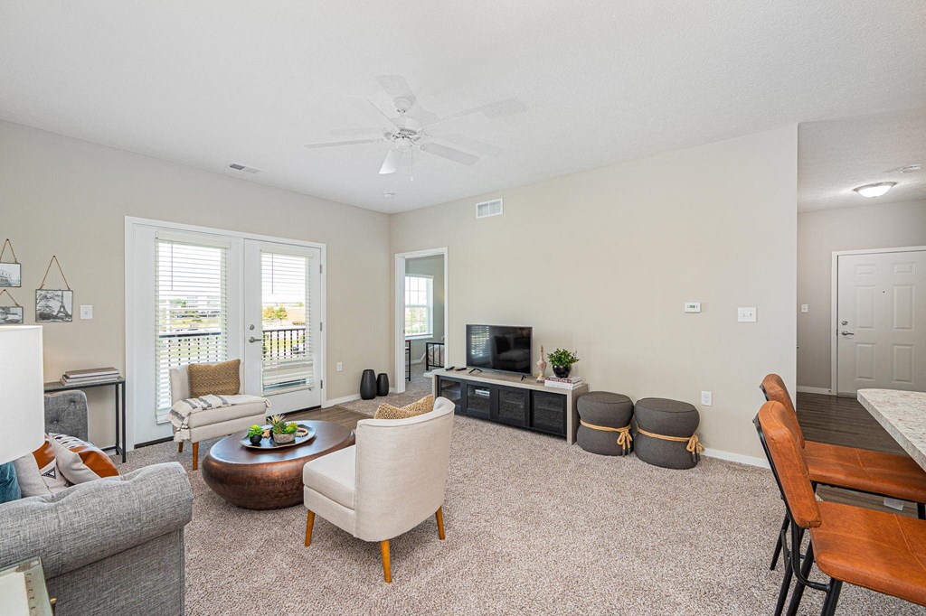 a living room with furniture and a ceiling fan