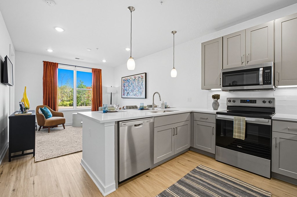 A modern kitchen with a large island and stainless steel appliances.