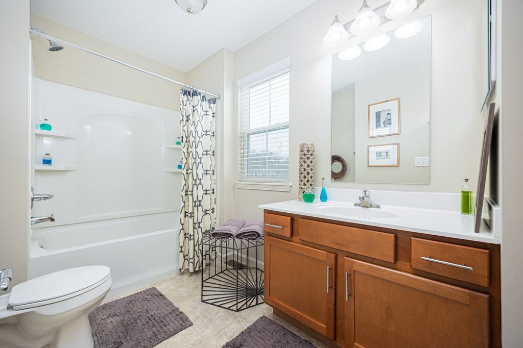 A bathroom with a white toilet, a white sink, and a white bathtub.