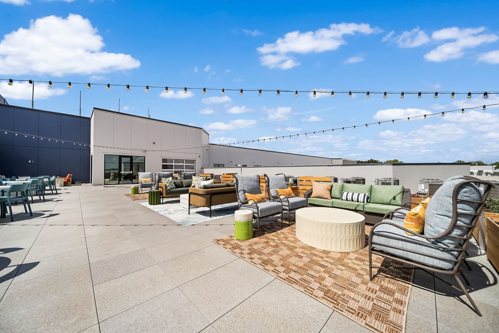 A patio with a lot of furniture and a blue sky.