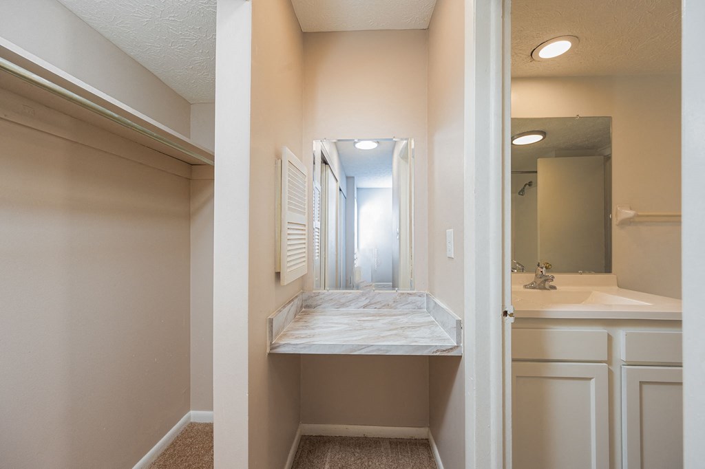 an empty bathroom with a sink and a mirror