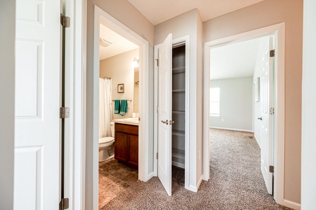 a view of a bathroom with a toilet and a closet