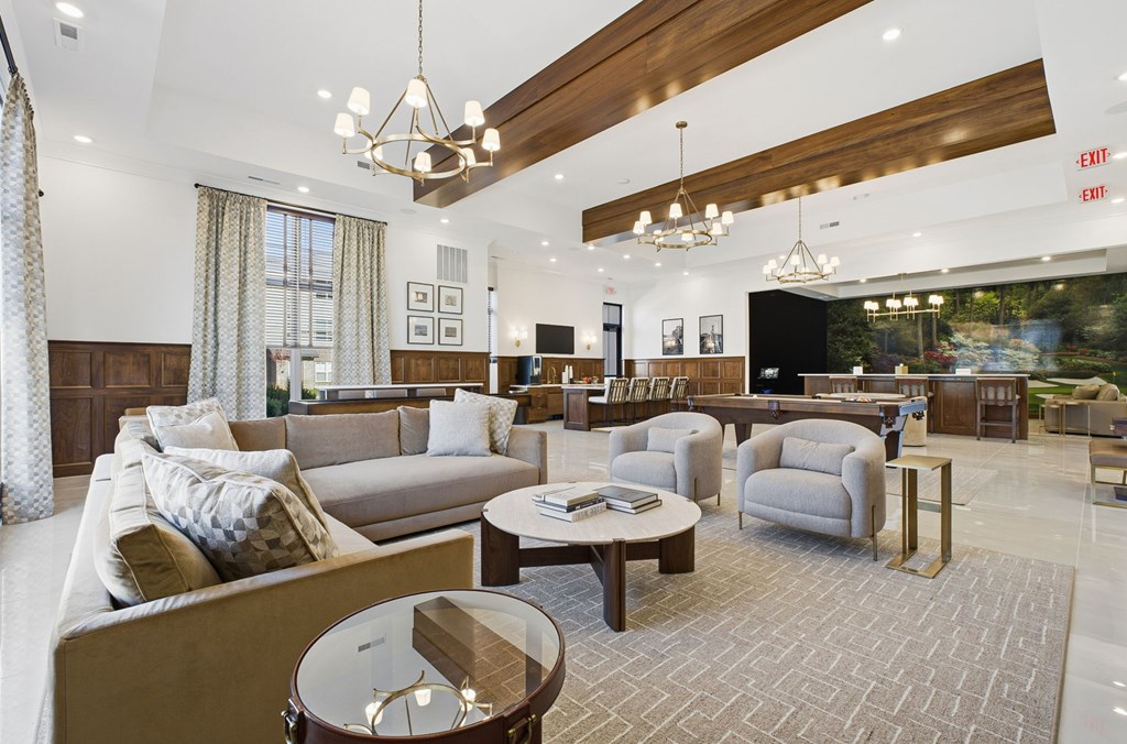 A spacious living room with a variety of seating options and a coffee table.