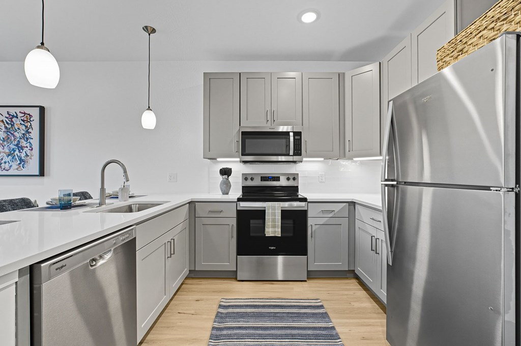 A modern kitchen with a stainless steel refrigerator.