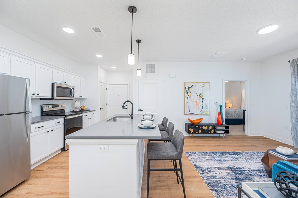 A modern kitchen with a dining area.