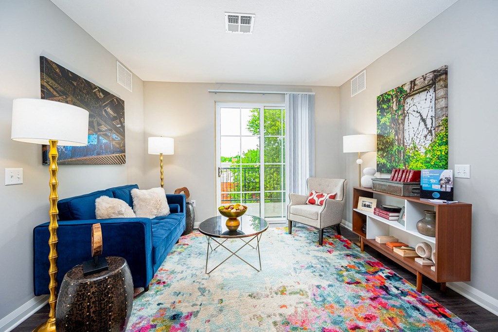 a living room with a blue couch and a window