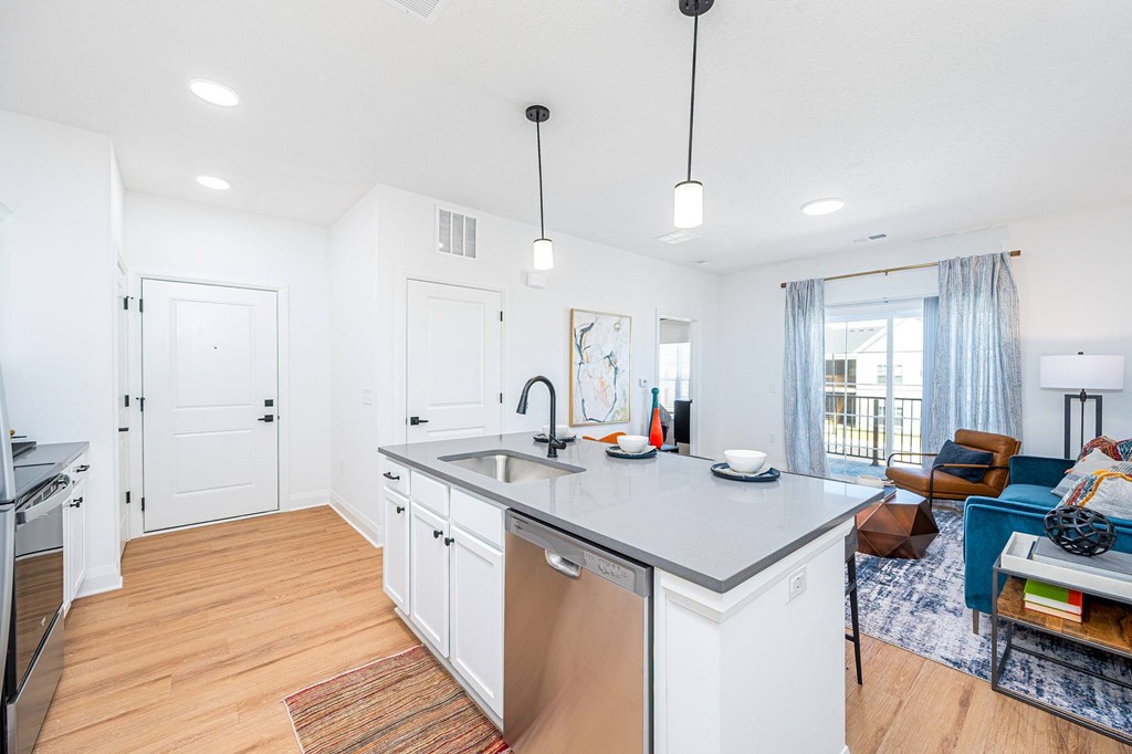 A kitchen with white cabinets and a large island.