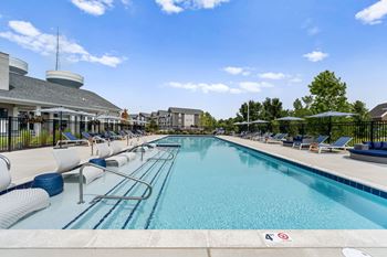 A large swimming pool with a blue tiled edge and a white line down the middle.