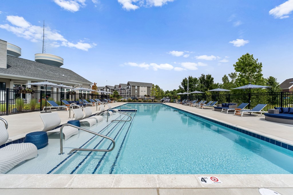 A large swimming pool with a blue tiled edge and a white line down the middle.