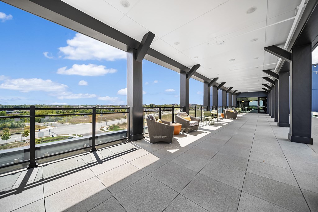 A long covered walkway with a view of the outdoors.
