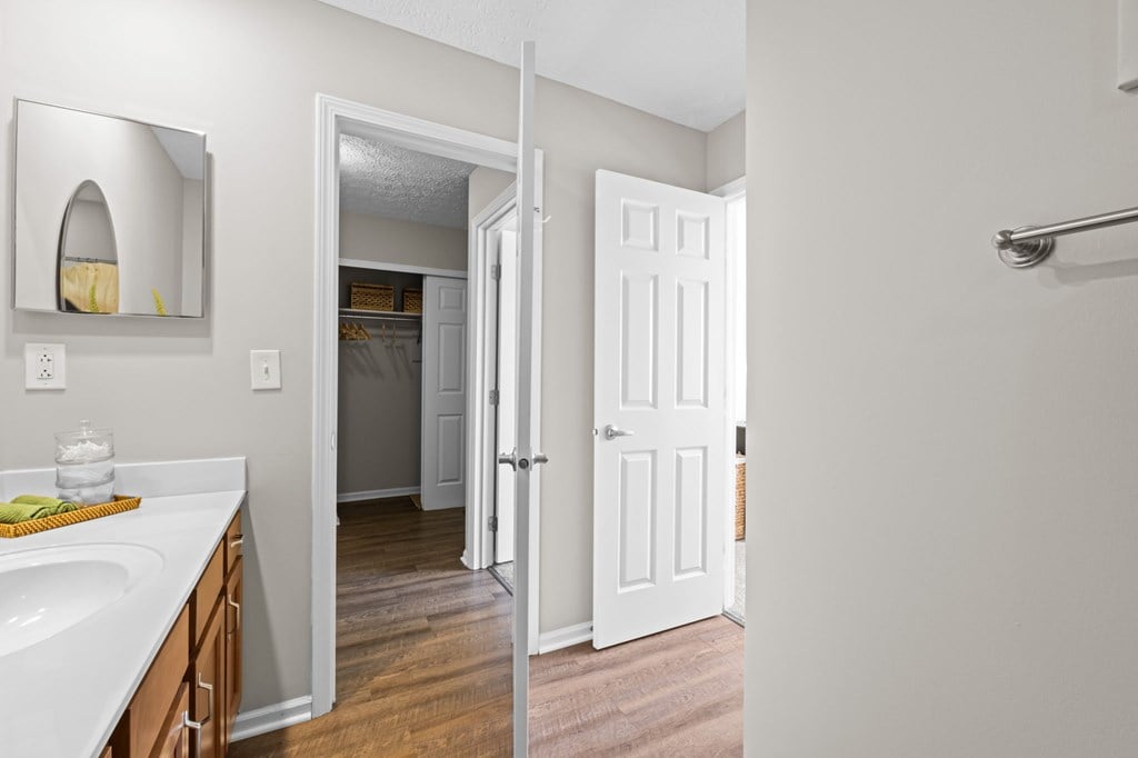 A bathroom with a white sink and a white door.