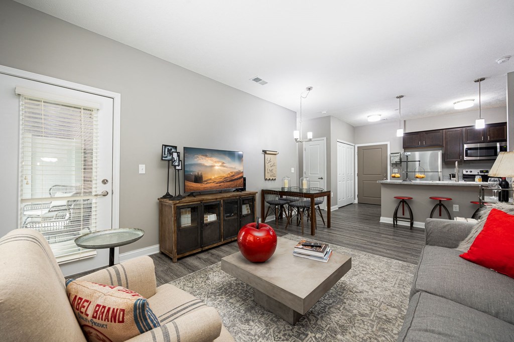 a living room with a couch and a table with a television