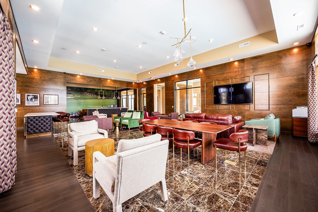 A room with a long table surrounded by chairs.