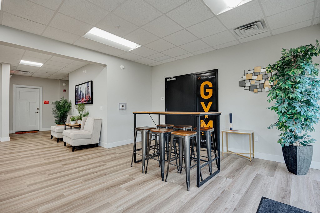 a dining room with a table and chairs and a blackboard with the word go