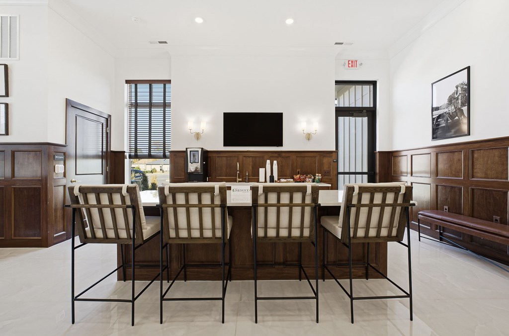 A dining room with a long table and chairs.