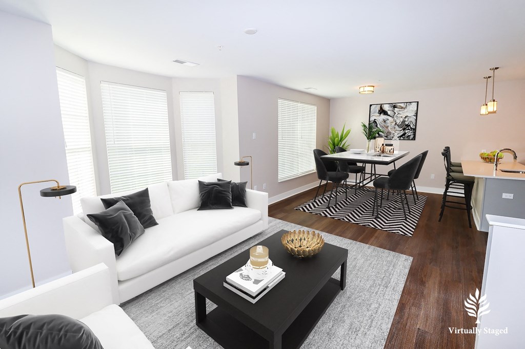 a living room with white couches and a black coffee table