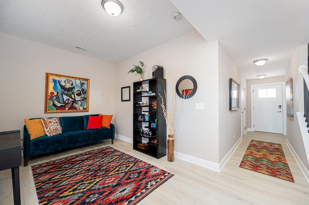 a living room with a couch and a door to a hallway