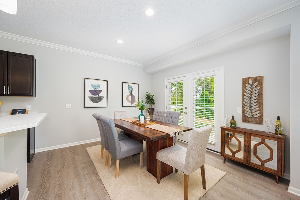 a dining room with a wooden table and chairs