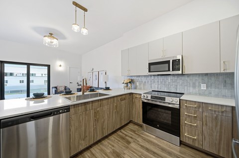 A modern kitchen with wooden cabinets and stainless steel appliances.