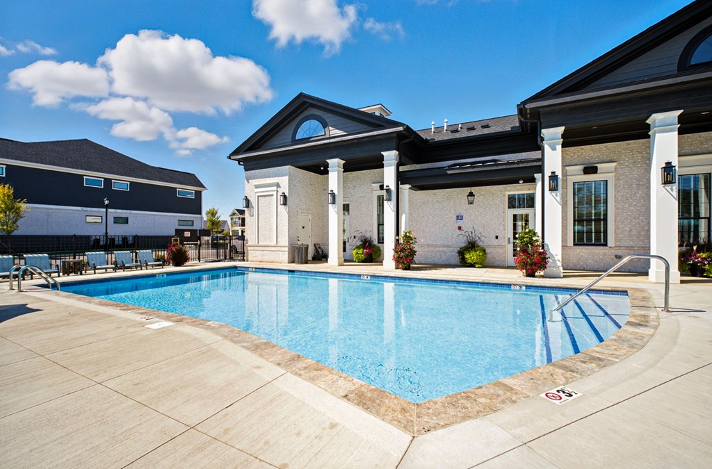 A pool surrounded by a building with columns.