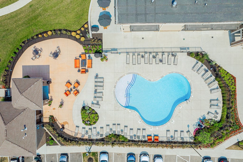 an aerial view of a swimming pool in a parking lot