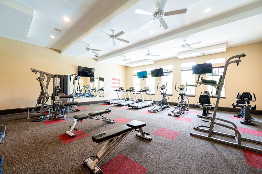 a gym with weights and other exercise equipment in a large room