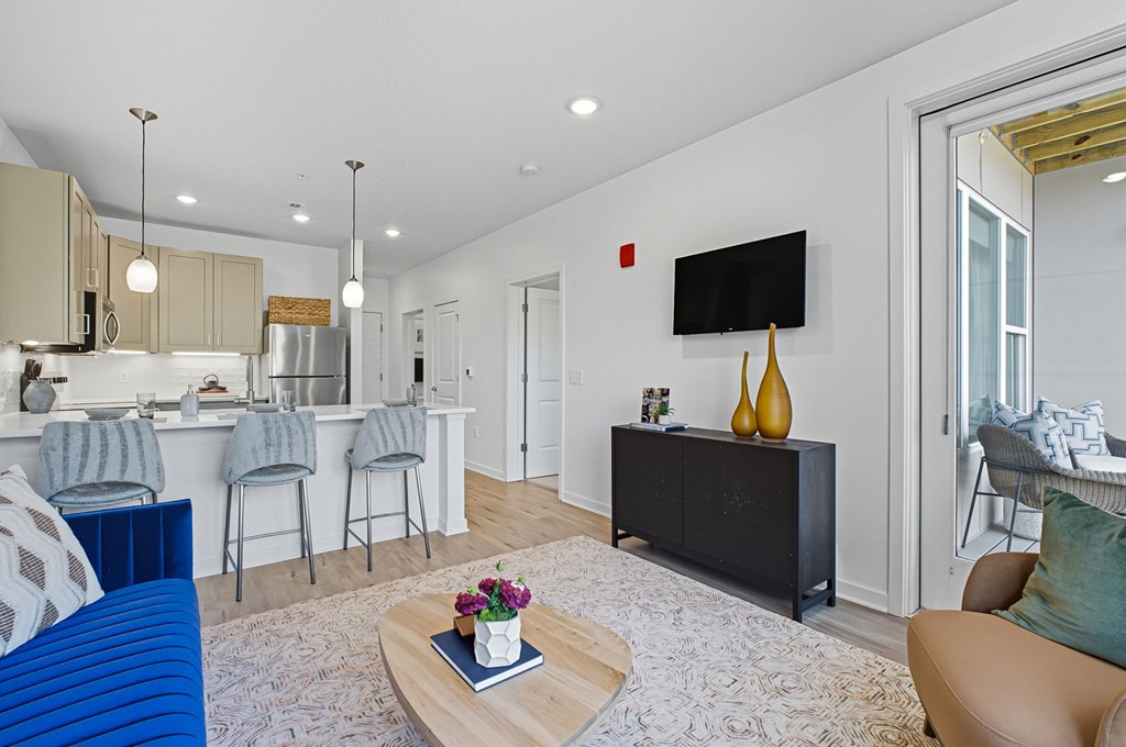 A modern living room with a blue couch and a wooden coffee table.
