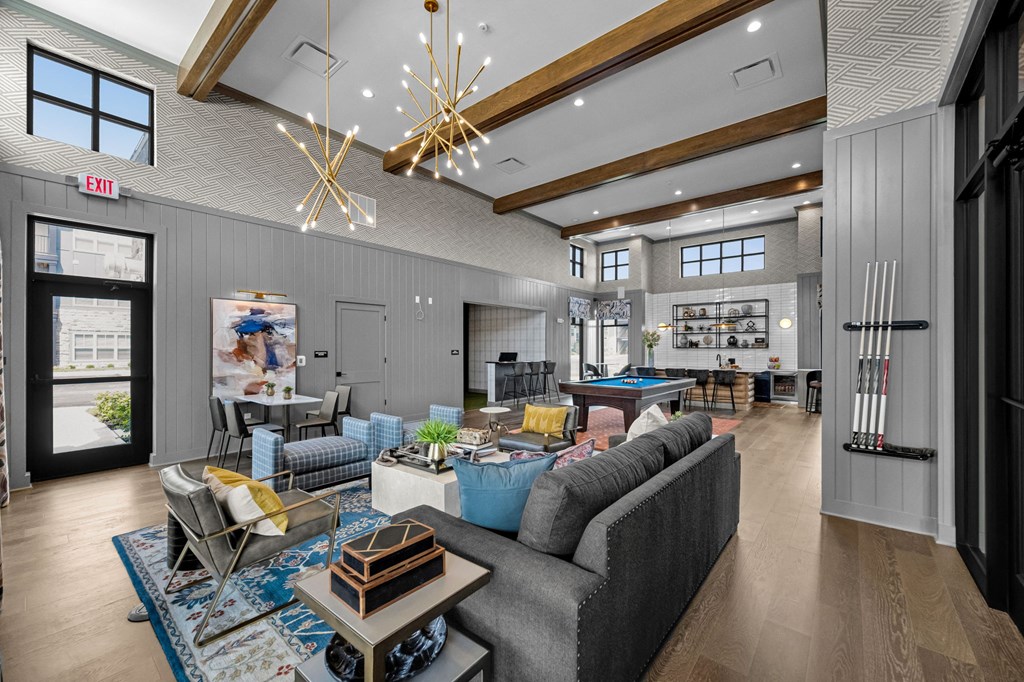 A modern living room with a grey sofa and a wooden coffee table.