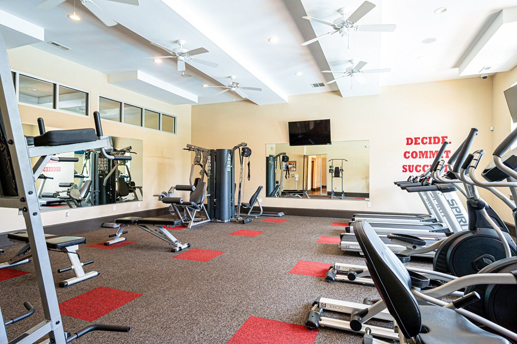 a gym with weights and cardio equipment at the flats