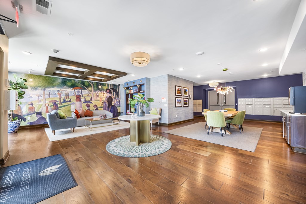 A living room with a wooden floor and a large mural on the wall.