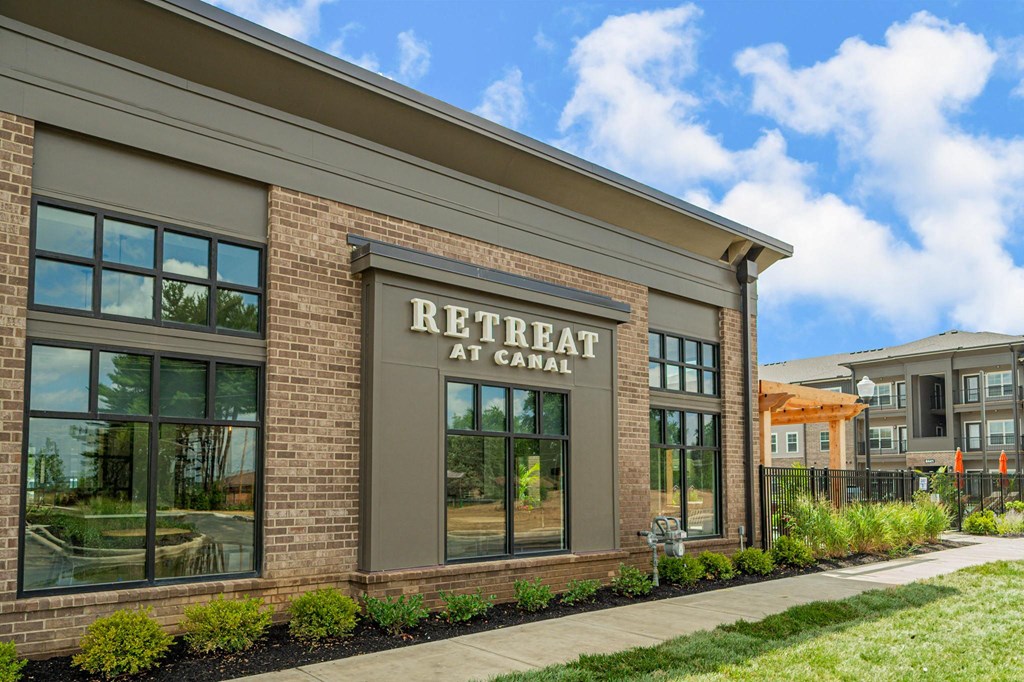 a brick building with a sign that reads retreat at canal
