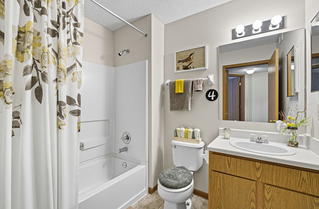A bathroom with a toilet, sink, and bathtub.