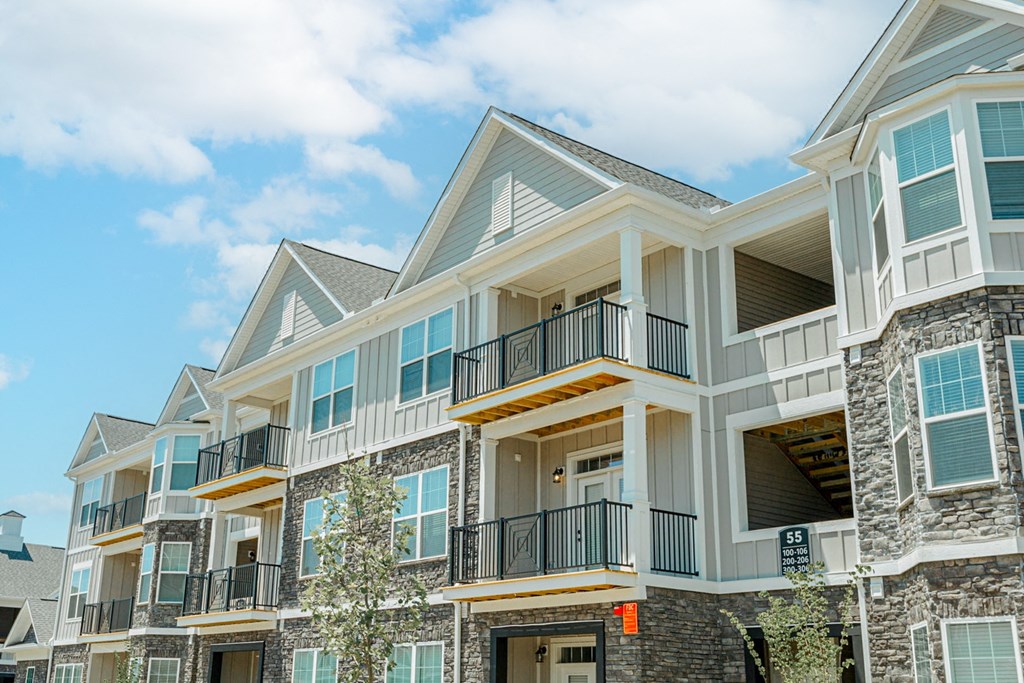 a row of homes with balconies on a sunny day