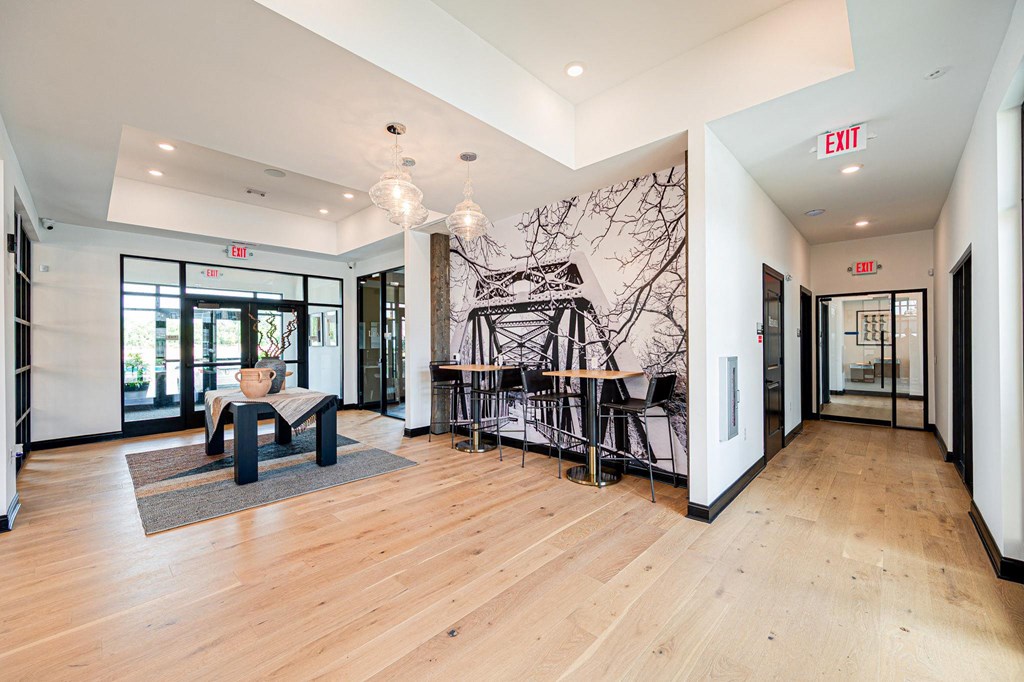 a living room with a chair and a table and a wall mural