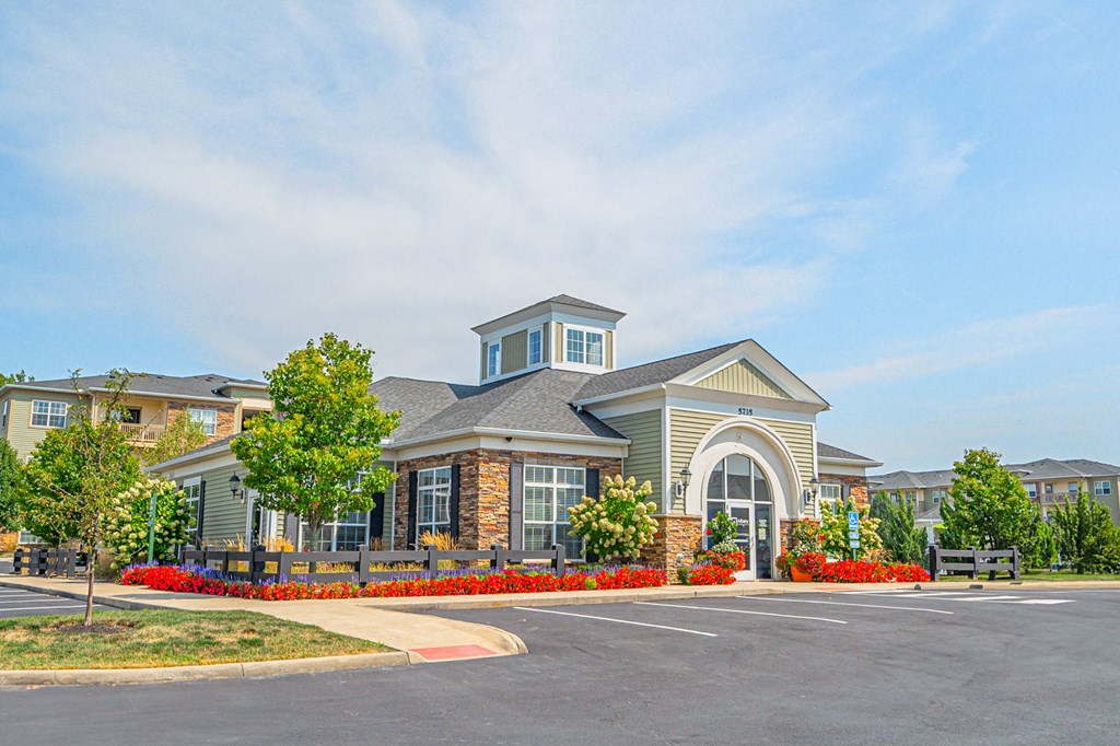 an exterior view of a building with a parking lot