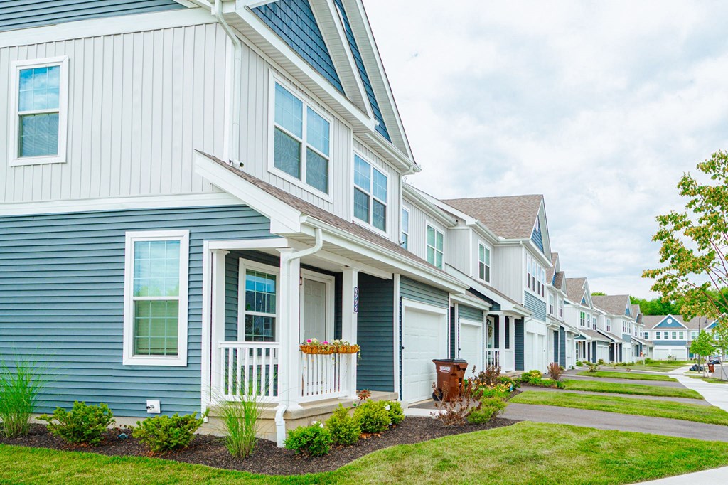 a row of houses with blue and white siding
