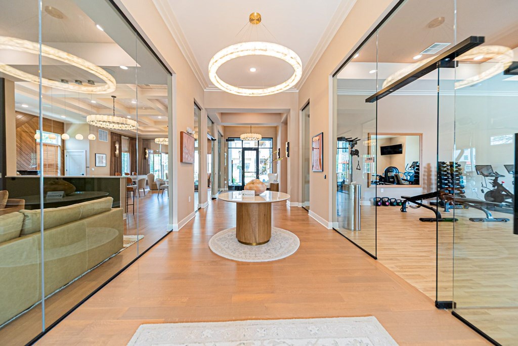 A spacious living room with a large mirror on the wall.