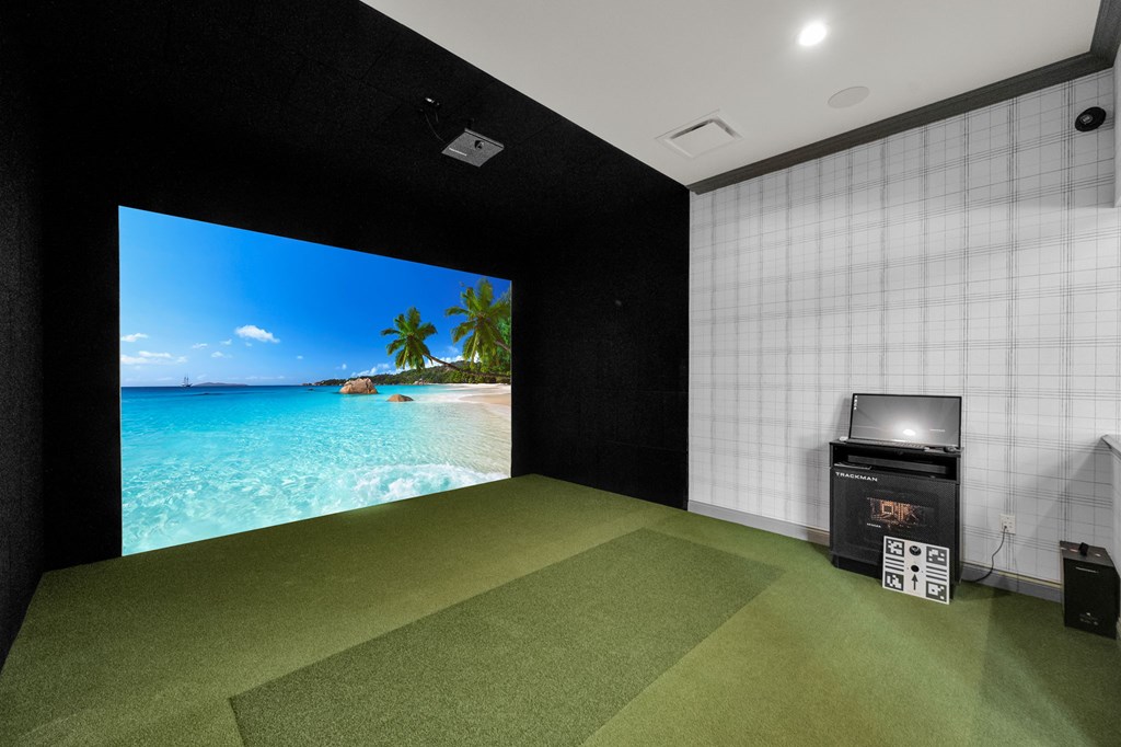 A room with a large screen and a projector.