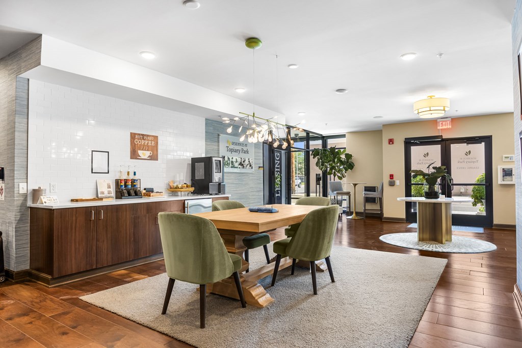 A modern dining room with a wooden table and green chairs.