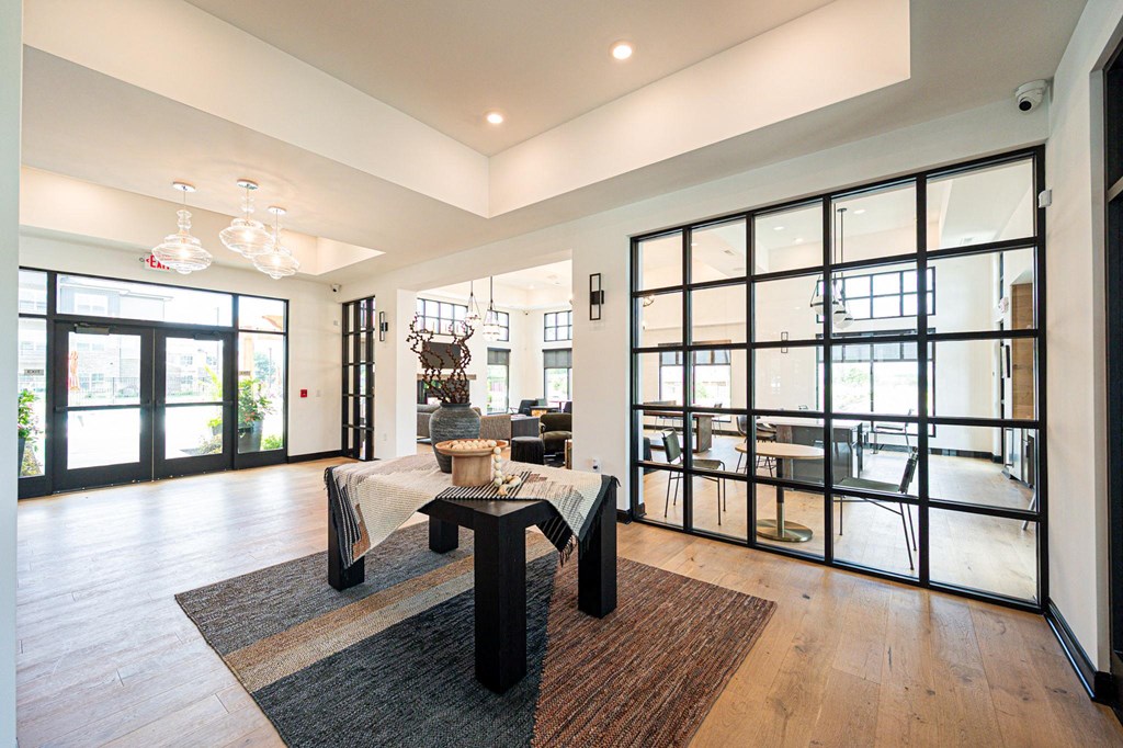 a large living room with glass doors and a table