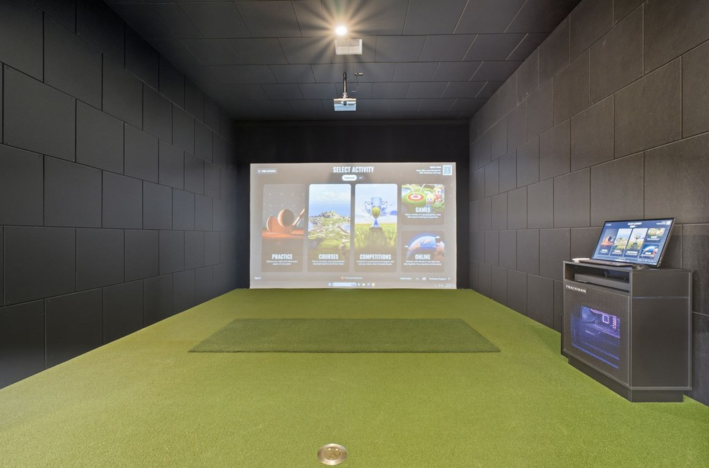 A room with a green carpet and a screen displaying a menu.