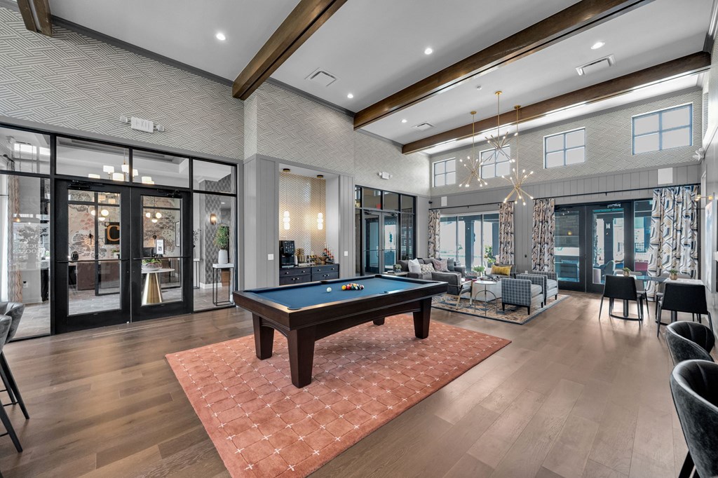 A large room with a pool table and a billiard table.