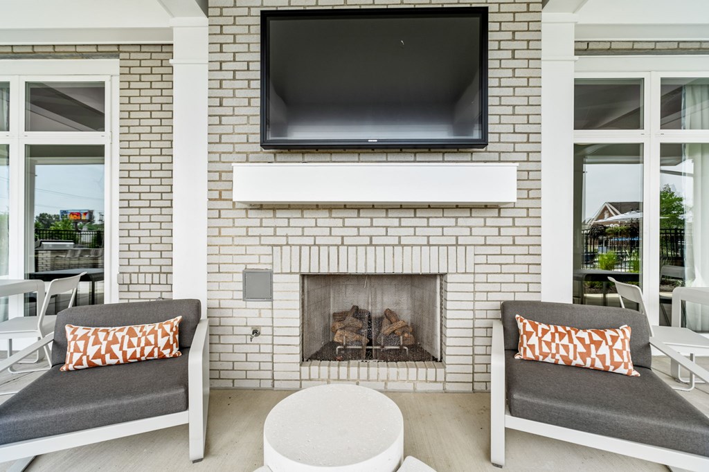 A white fireplace with a flat screen TV above it.