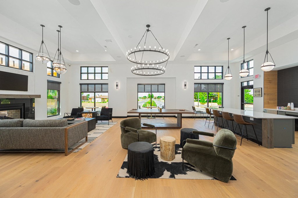 a large living room with couches and chairs and a fireplace