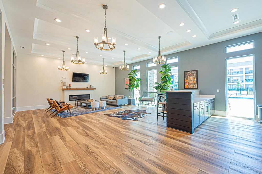 a living room with a fireplace and a table and chairs