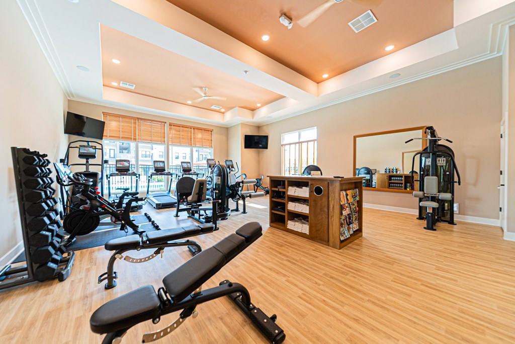 A spacious home gym with a variety of equipment.