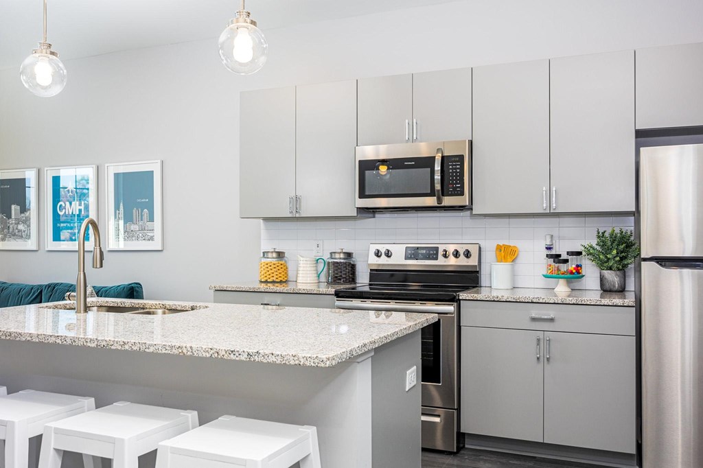 a kitchen with stainless steel appliances and granite counter tops