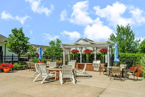 an outdoor patio with tables and chairs and a gazebo