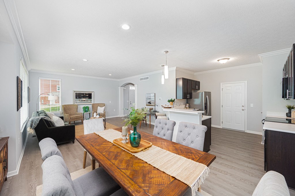 a living room and dining room with a wooden table